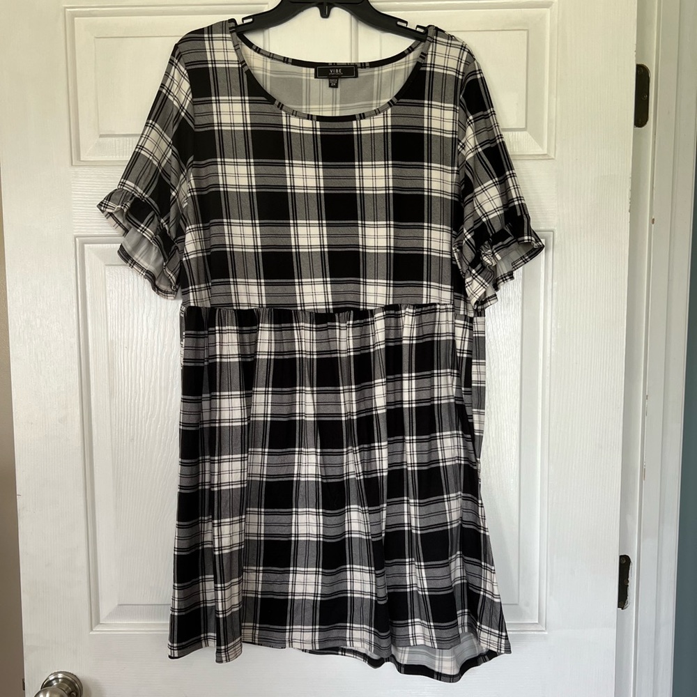 Black and white checkered dress with ruffled sleeves.